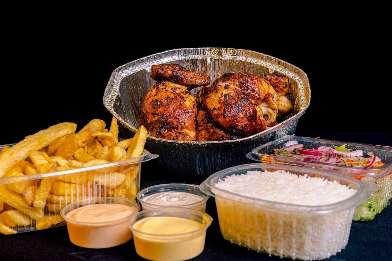 about-us Mouthwatering rotisserie chicken with fries, sauces, rice, and salad, perfect for a hearty meal.